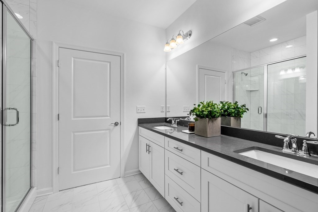 82 Shannon Way, Unit 98 Upton, MA 01568 - Photo 10 of 18 a bathroom with a granite countertop sink and a mirror
