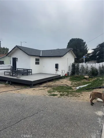 a view of a house with swimming pool and sitting area