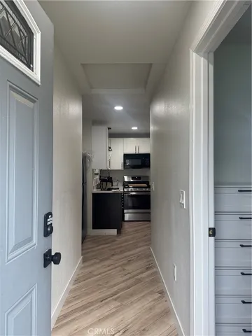 a kitchen with stainless steel appliances kitchen island granite countertop a refrigerator and a sink