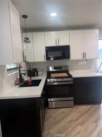 a kitchen with a sink stove and cabinets