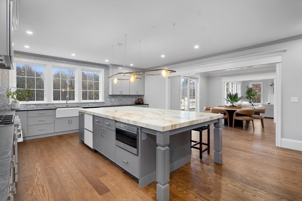 98 Heather Lane Needham, MA 02492 - Photo 18 of 31 a kitchen with stainless steel appliances granite countertop a stove and a wooden floors