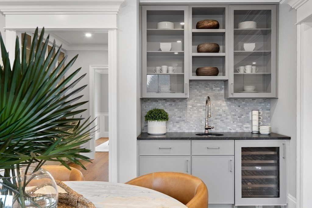 98 Heather Lane Needham, MA 02492 - Photo 22 of 31 a kitchen with a white cabinets and a potted plant