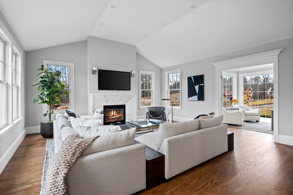 98 Heather Lane Needham, MA 02492 - Photo 24 of 31 a living room with furniture a fireplace and a flat screen tv