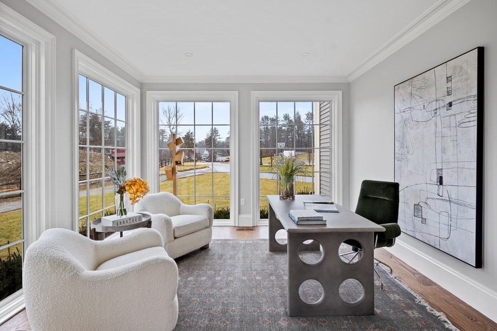 98 Heather Lane Needham, MA 02492 - Photo 25 of 31 a living room with furniture a flat screen tv and a floor to ceiling window