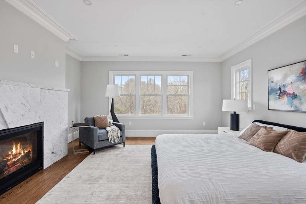 98 Heather Lane Needham, MA 02492 - Photo 26 of 31 a bedroom with furniture and a fireplace