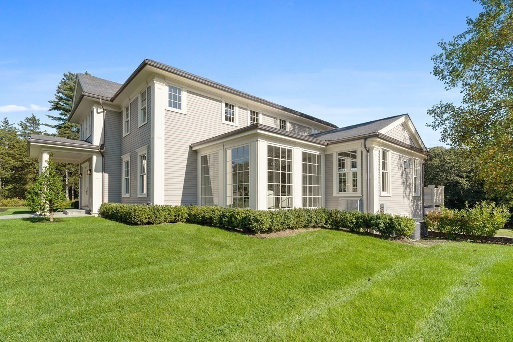 98 Heather Lane Needham, MA 02492 - Photo 8 of 31 a front view of a house with a yard