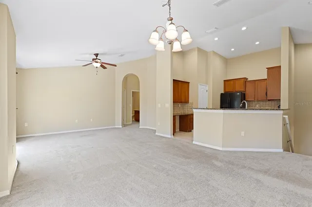 a view of a kitchen with a refrigerator and a ceiling fan