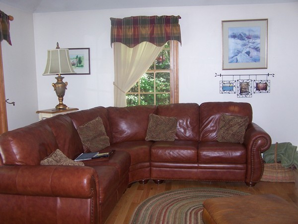 40 Porter Road Boxford, MA 01921 - Photo 2 of 16 a blue couch sitting in a living room with a couch
