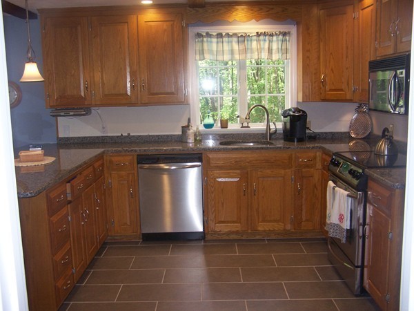 40 Porter Road Boxford, MA 01921 - Photo 4 of 16 a kitchen with stainless steel appliances granite countertop a stove a sink and a microwave