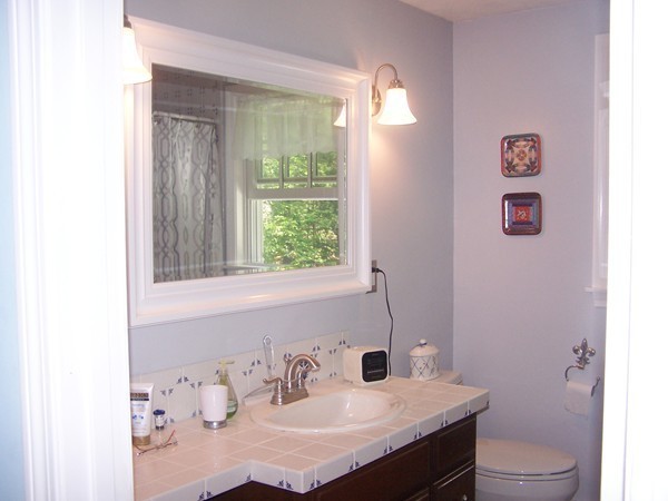 40 Porter Road Boxford, MA 01921 - Photo 8 of 16 a bathroom with a sink vanity mirror and toilet