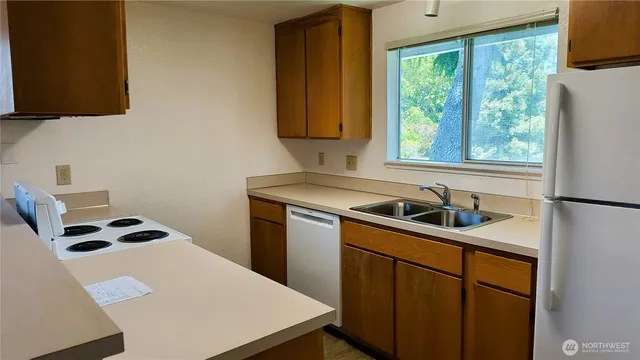 a kitchen with a sink a stove and a microwave