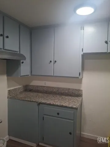 a view of a empty room with wooden floor