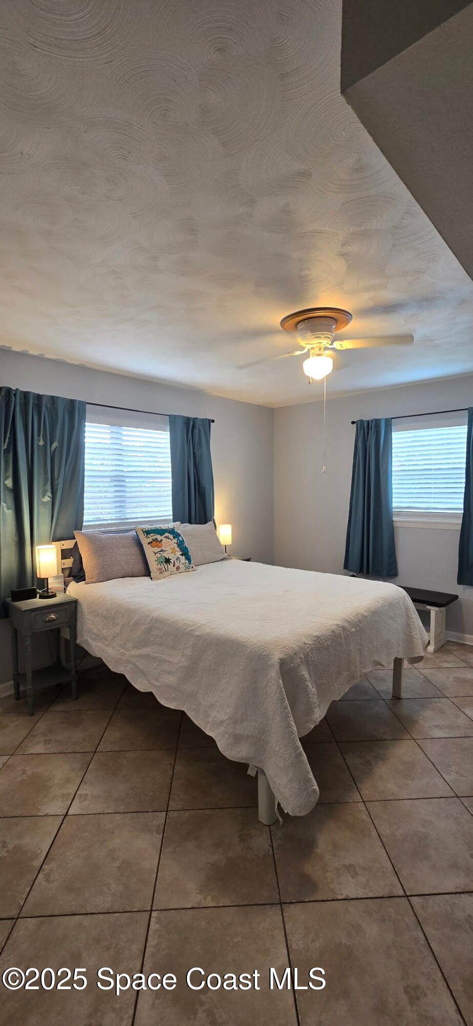 415 Madison Avenue, Unit I102 Cape Canaveral, FL 32920 - Photo 12 of 29 a bedroom with a bed and window