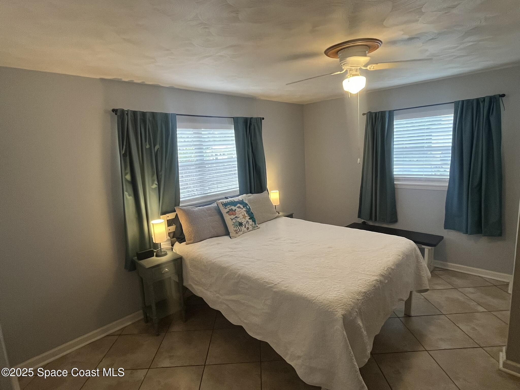 415 Madison Avenue, Unit I102 Cape Canaveral, FL 32920 - Photo 18 of 29 a bedroom with a bed and window
