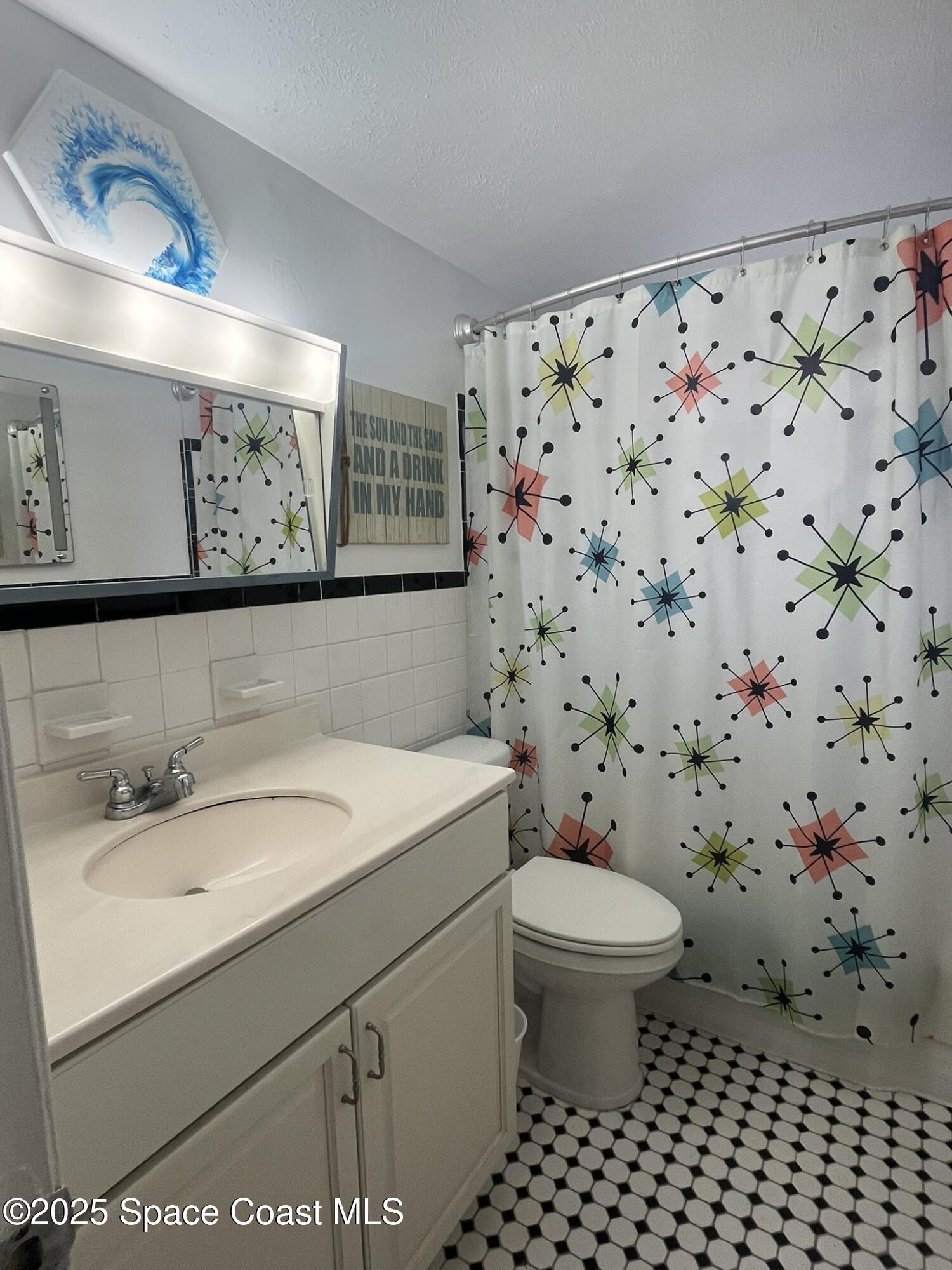 415 Madison Avenue, Unit I102 Cape Canaveral, FL 32920 - Photo 19 of 29 a bathroom with a sink and a toilet