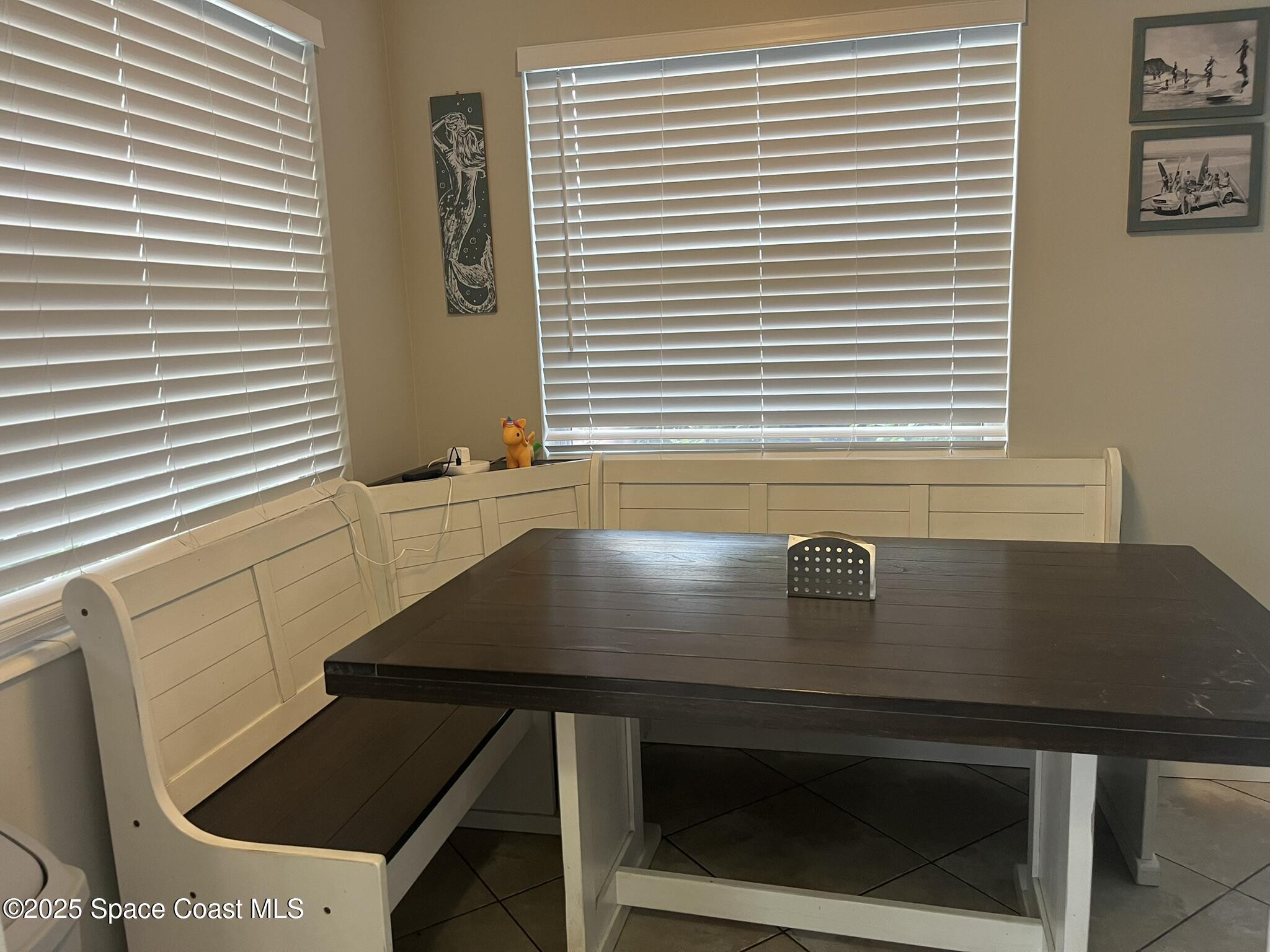 415 Madison Avenue, Unit I102 Cape Canaveral, FL 32920 - Photo 25 of 29 a view of a kitchen with kitchen island a sink a stove and a window