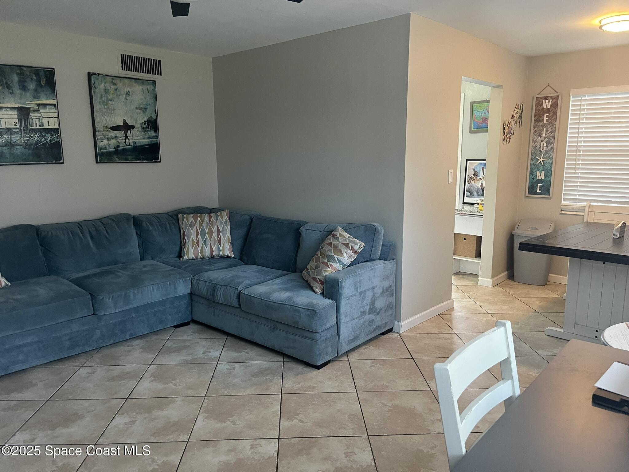 415 Madison Avenue, Unit I102 Cape Canaveral, FL 32920 - Photo 26 of 29 a living room with furniture and a couch
