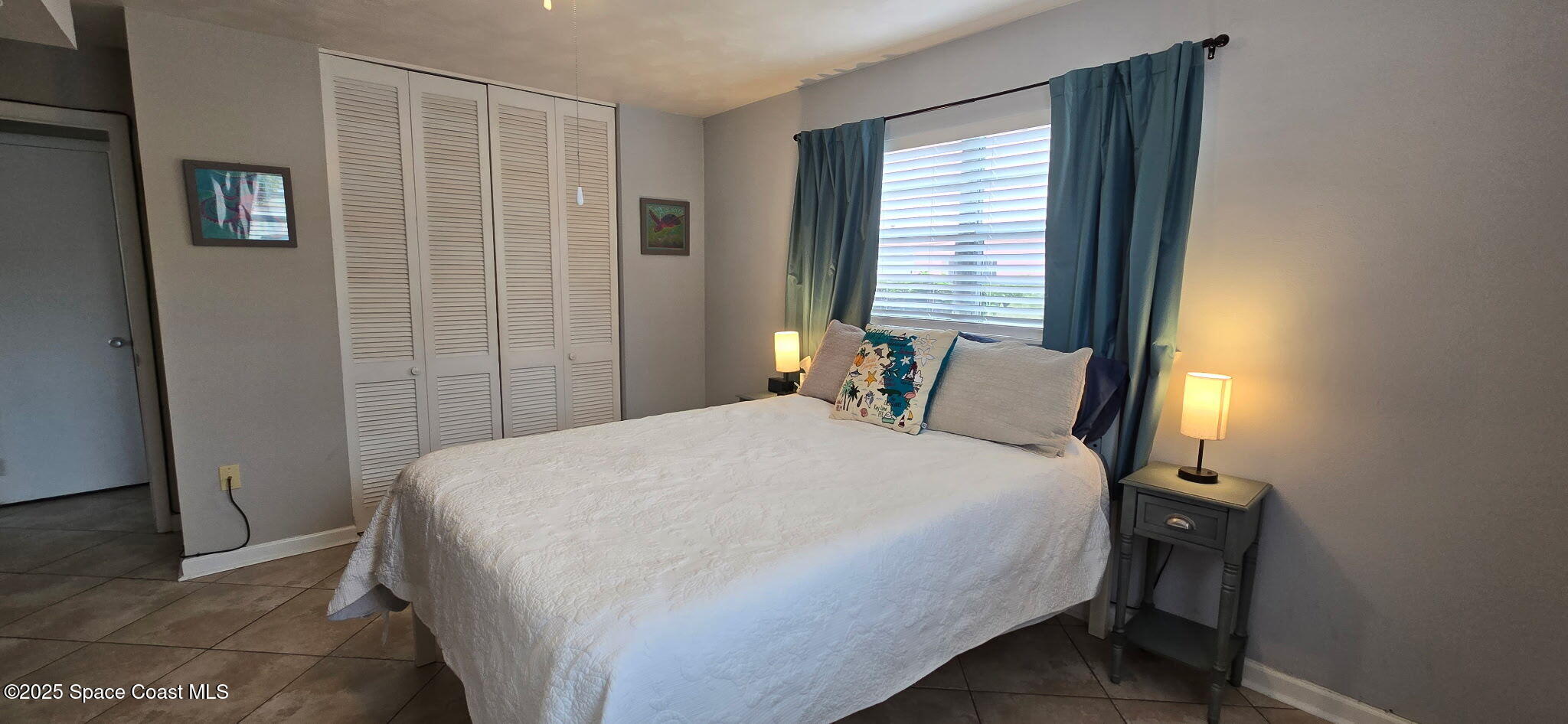 415 Madison Avenue, Unit I102 Cape Canaveral, FL 32920 - Photo 9 of 29 a bedroom with a bed and a window