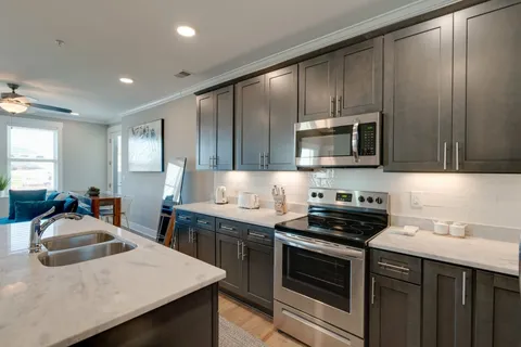 a kitchen that has a sink and a stove top oven