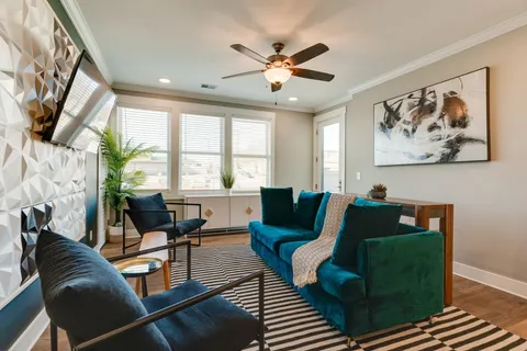 a living room with furniture and a large window