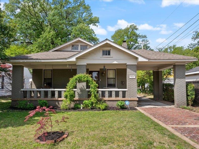 a front view of a house with a yard and porch