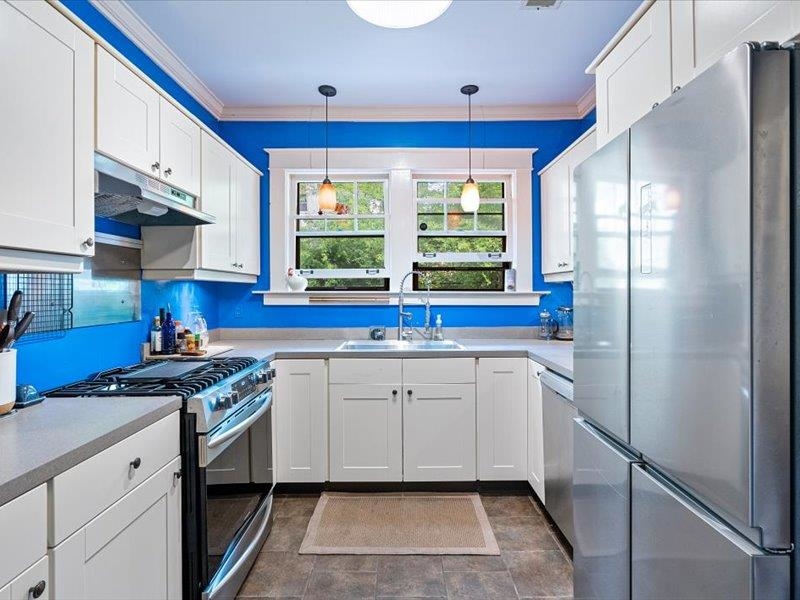793 Rozelle Street Memphis, TN 38104 - Photo 13 of 33 a kitchen with stainless steel appliances granite countertop a sink stove and refrigerator