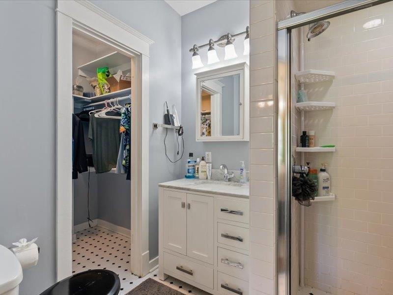 793 Rozelle Street Memphis, TN 38104 - Photo 21 of 33 a en suite bathroom with a sink a mirror and a shower