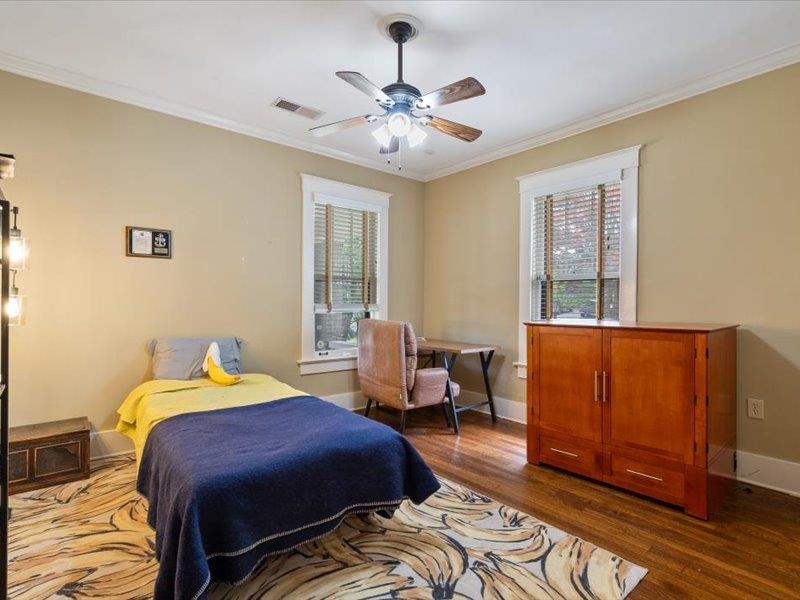 793 Rozelle Street Memphis, TN 38104 - Photo 23 of 33 a bedroom with a bed and wooden floor