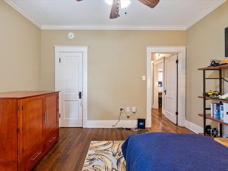 793 Rozelle Street Memphis, TN 38104 - Photo 24 of 33 a bedroom with a bed and wooden floor