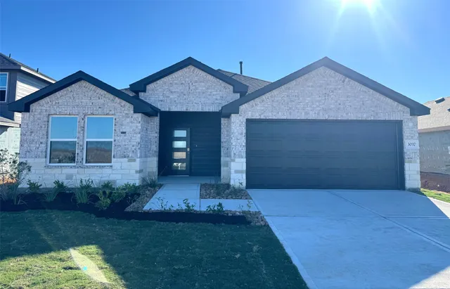 a front view of a house with a yard and pathway