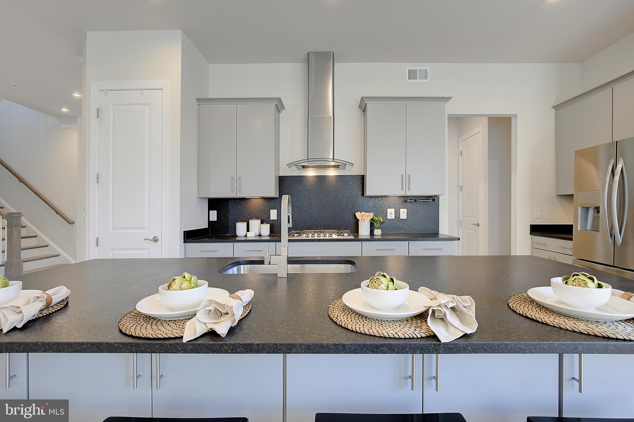 1126 White Clover Lane Odenton, MD 21113 - Photo 13 of 92 a kitchen with granite countertop a table and chairs