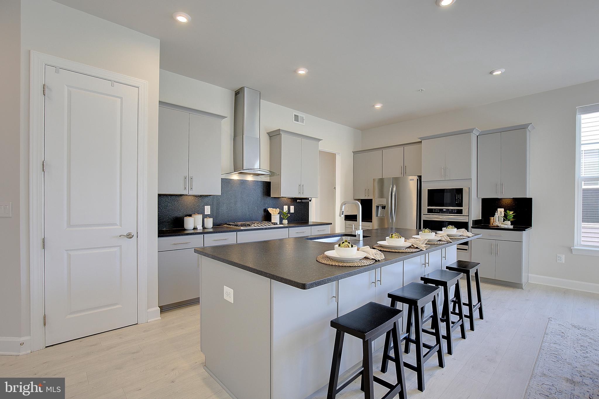 1126 White Clover Lane Odenton, MD 21113 - Photo 15 of 92 a kitchen with stainless steel appliances granite countertop a stove a sink a refrigerator and a dining table