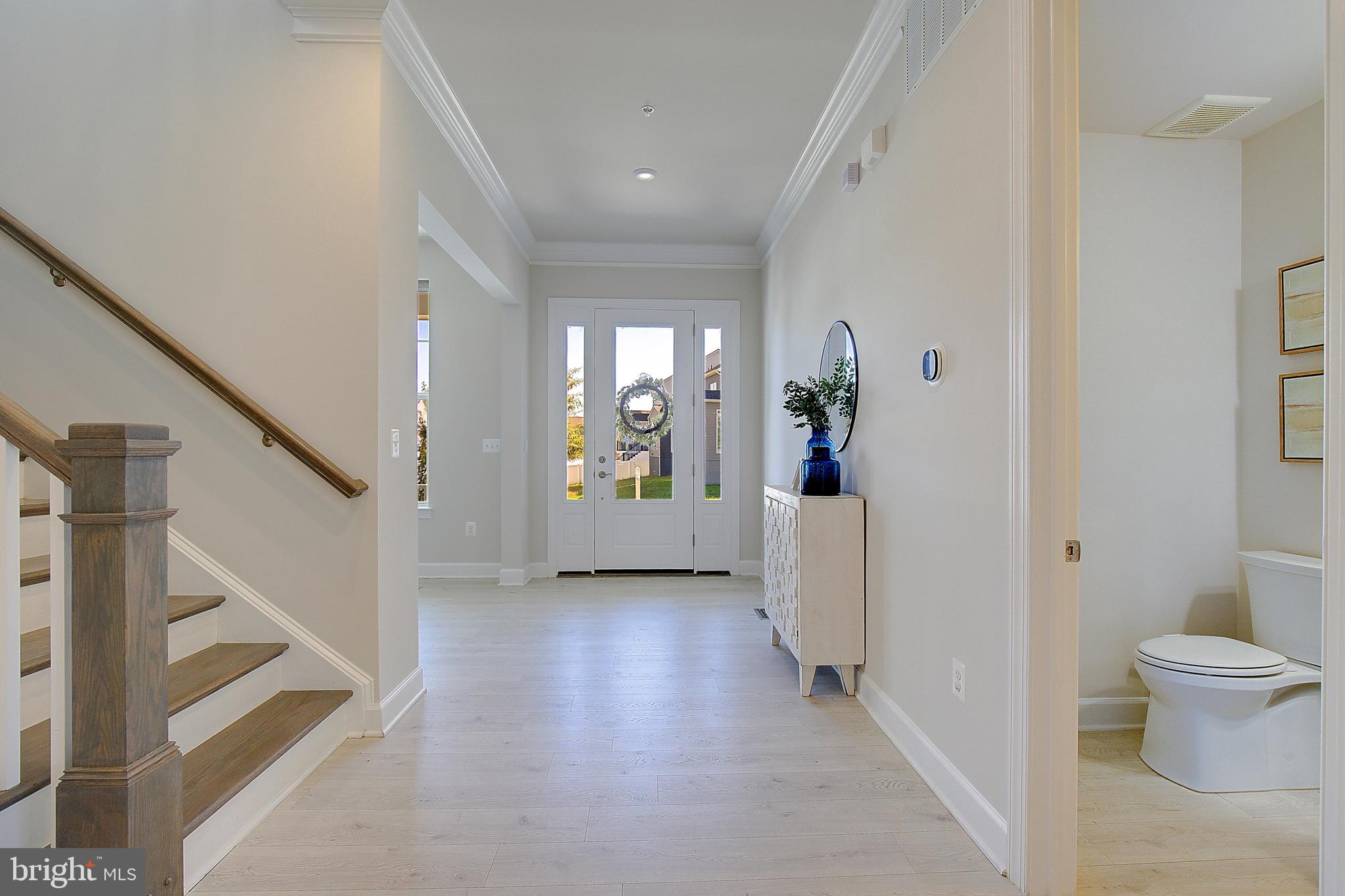 1126 White Clover Lane Odenton, MD 21113 - Photo 26 of 92 a view of a hallway view with wooden floor and staircase