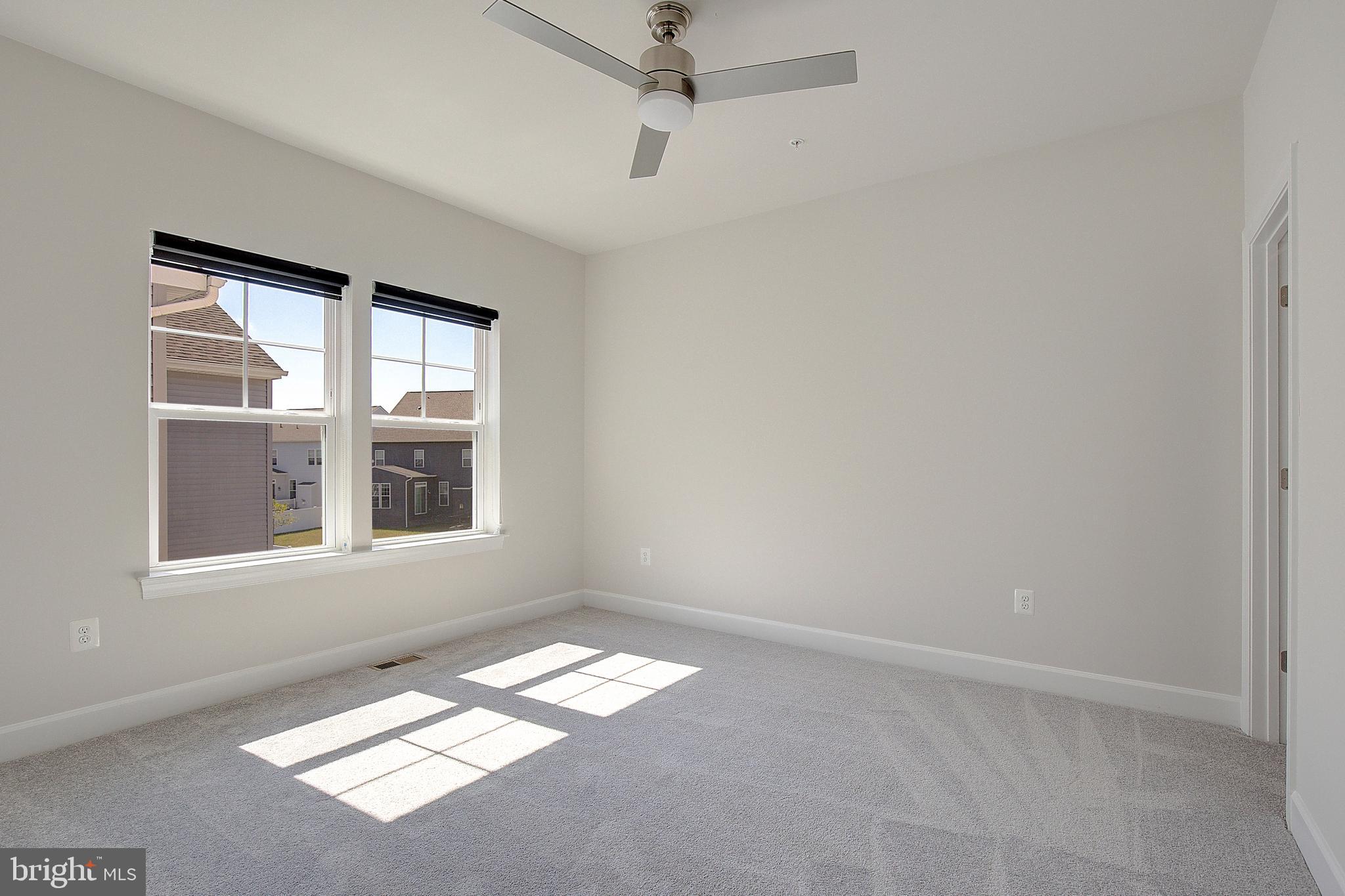 1126 White Clover Lane Odenton, MD 21113 - Photo 45 of 92 an empty room with windows and ceiling fan