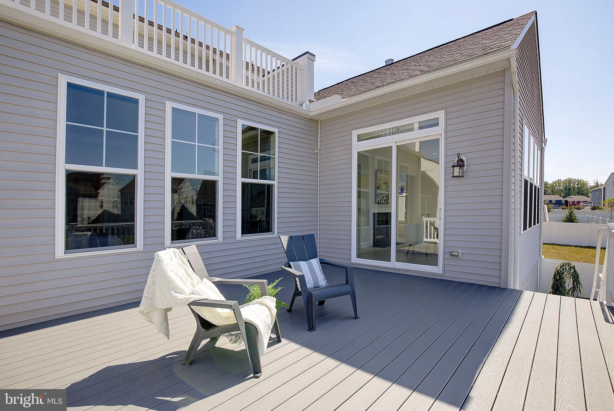 1126 White Clover Lane Odenton, MD 21113 - Photo 60 of 92 a view of a deck with table and chairs and wooden floor