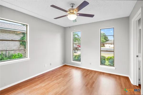 wooden floor in an empty room with a window