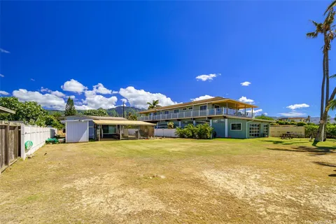 a view of a swimming pool with a bench in front of house