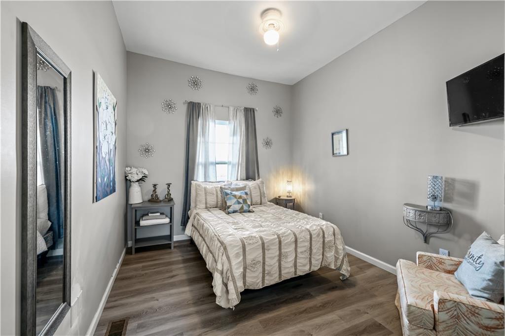 2220 Lee Street Southwest Covington, GA 30014 - Photo 16 of 30 a bedroom with a bed a flat screen tv and a window