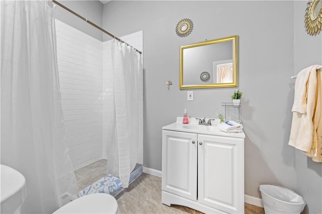 2220 Lee Street Southwest Covington, GA 30014 - Photo 24 of 30 a bathroom with a sink toilet and mirror
