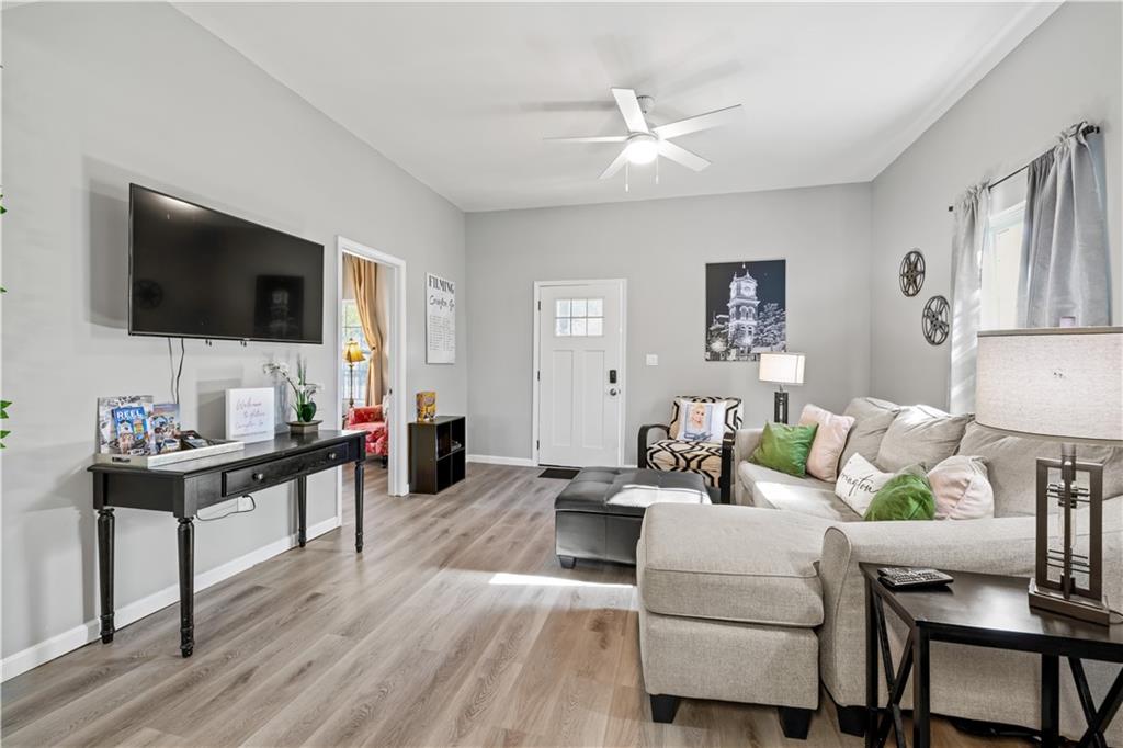 2220 Lee Street Southwest Covington, GA 30014 - Photo 6 of 30 a living room with furniture and a flat screen tv