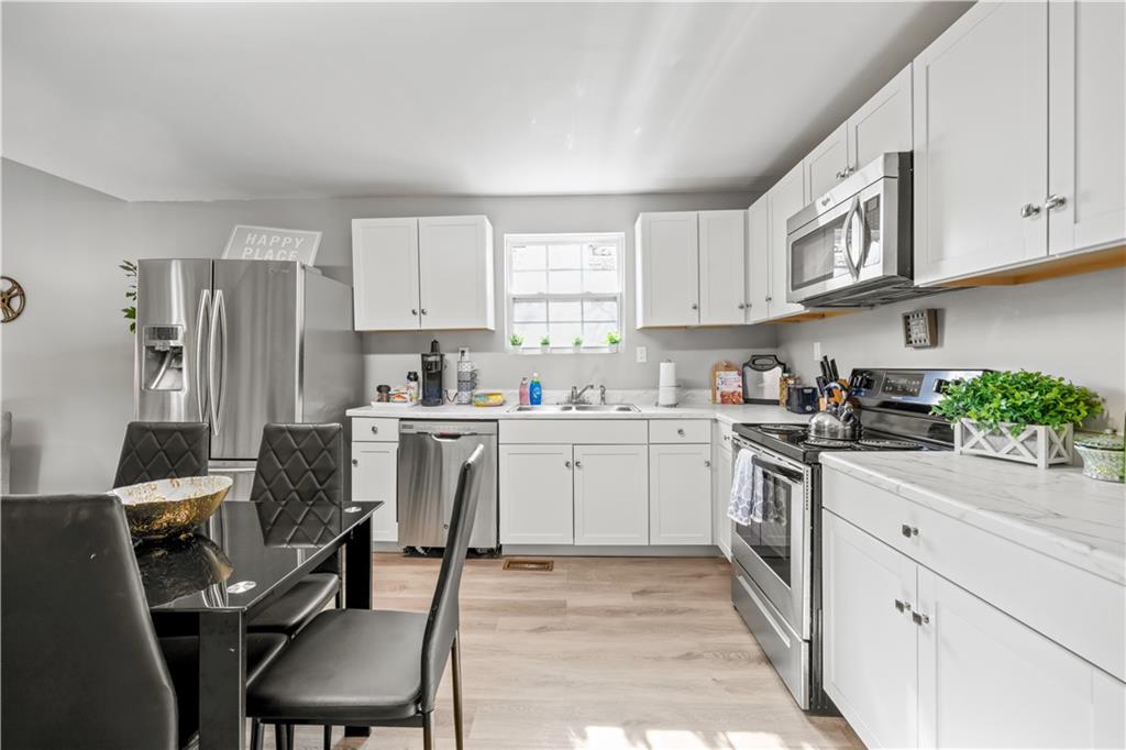 2220 Lee Street Southwest Covington, GA 30014 - Photo 8 of 30 a kitchen with white cabinets and white appliances