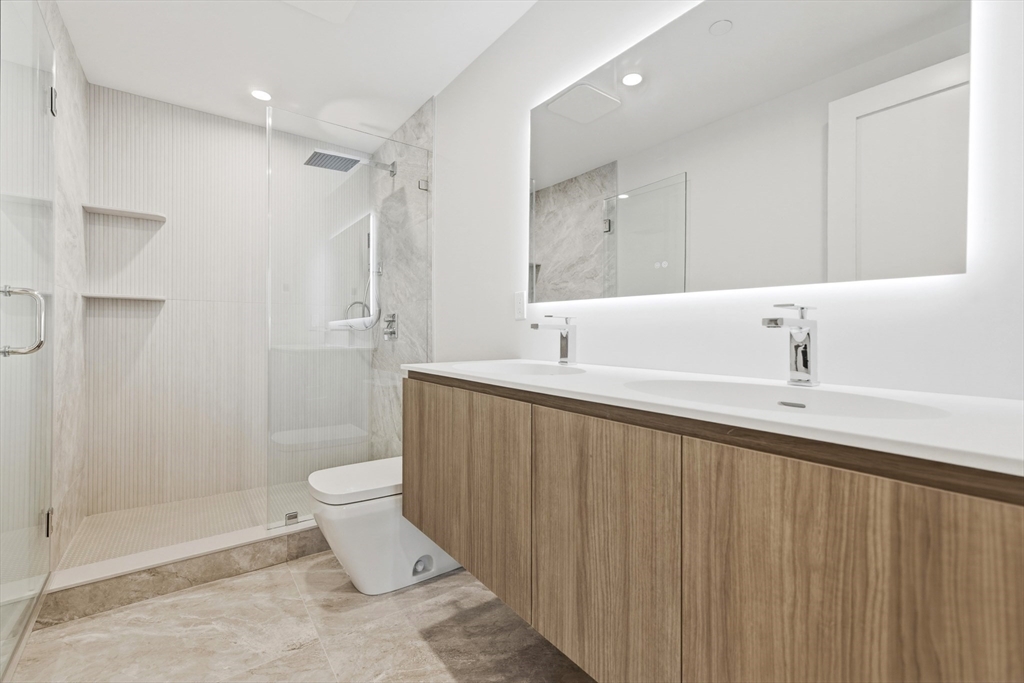 118 B Street, Unit 408 Boston, MA 02127 - Photo 5 of 11 a bathroom with a sink toilet and shower