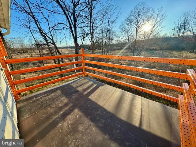a view of backyard with wooden fence and trees