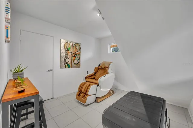 a room with furniture and a potted plant