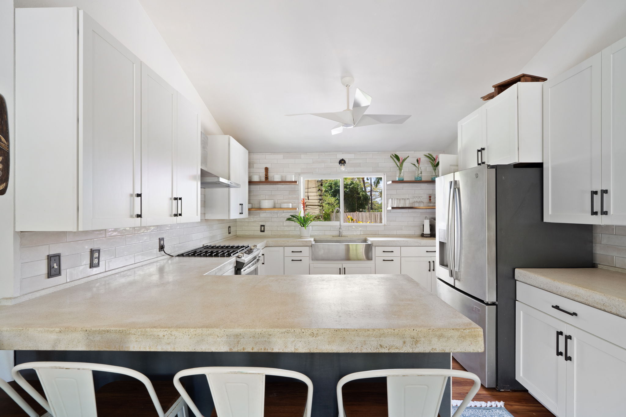 6100 Kawaihau Road Kapaa, HI 96746 - Photo 4 of 22 a kitchen with stainless steel appliances granite countertop a sink a stove and white cabinets