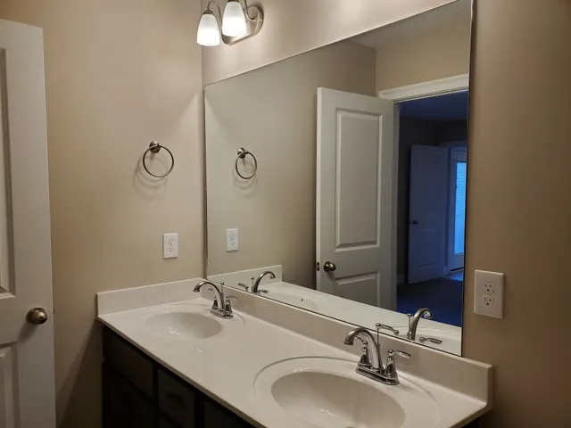 a bathroom with a sink vanity and mirror