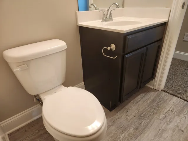 a bathroom with a sink toilet and a mirror