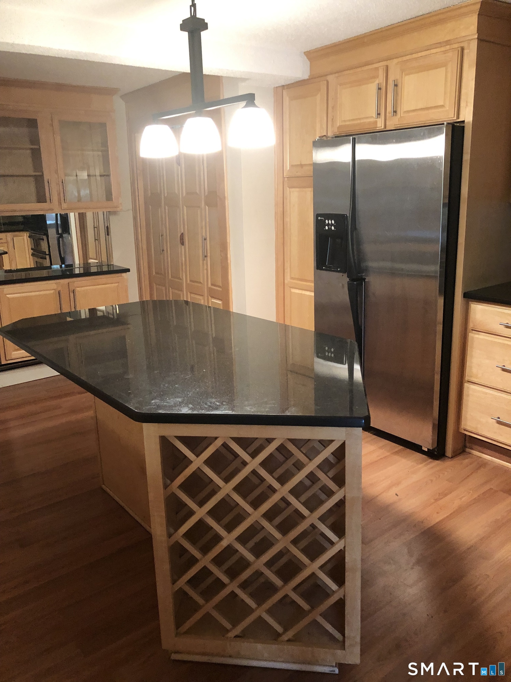311 Racebrook Road Orange, CT 06477 - Photo 2 of 12 a kitchen with stainless steel appliances a refrigerator a sink and wooden floor