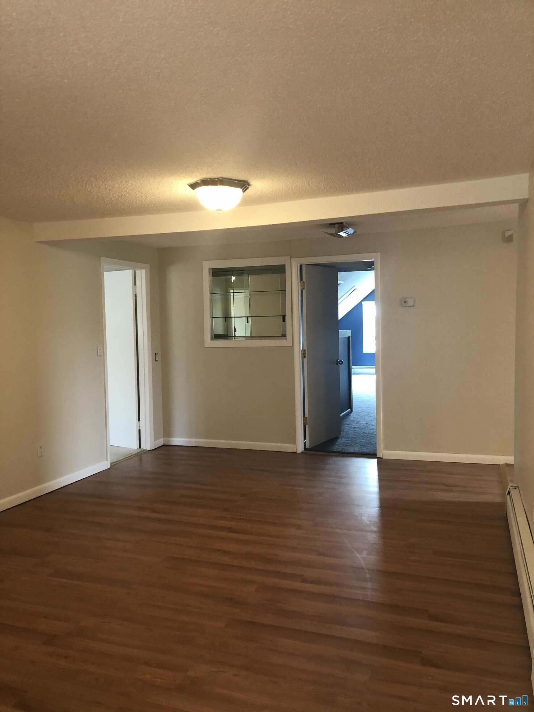 311 Racebrook Road Orange, CT 06477 - Photo 3 of 12 a view of empty room with wooden floor and fan