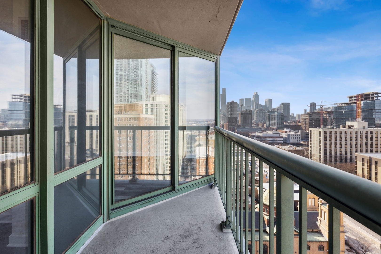 111 West Maple Street, Unit 1208 Chicago, IL 60610 - Photo 6 of 14 a view of a city from a balcony